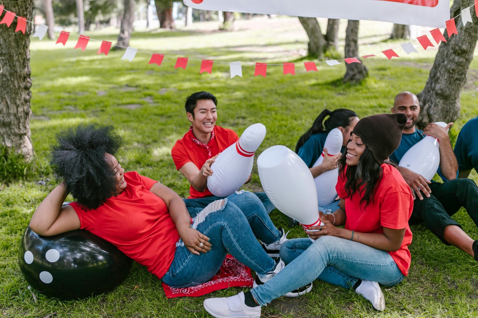 A diverse group enjoying team building games outdoors, creating a joyful and lively atmosphere.