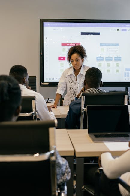 Professionals engaged in a meeting with a digital presentation in a conference room.